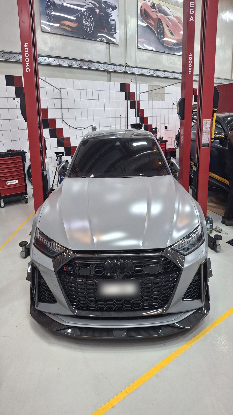 Nardo Grey Audi RS model on a two-post lift at Velokar Auto Repairing, Al Quoz Industrial 3, Dubai