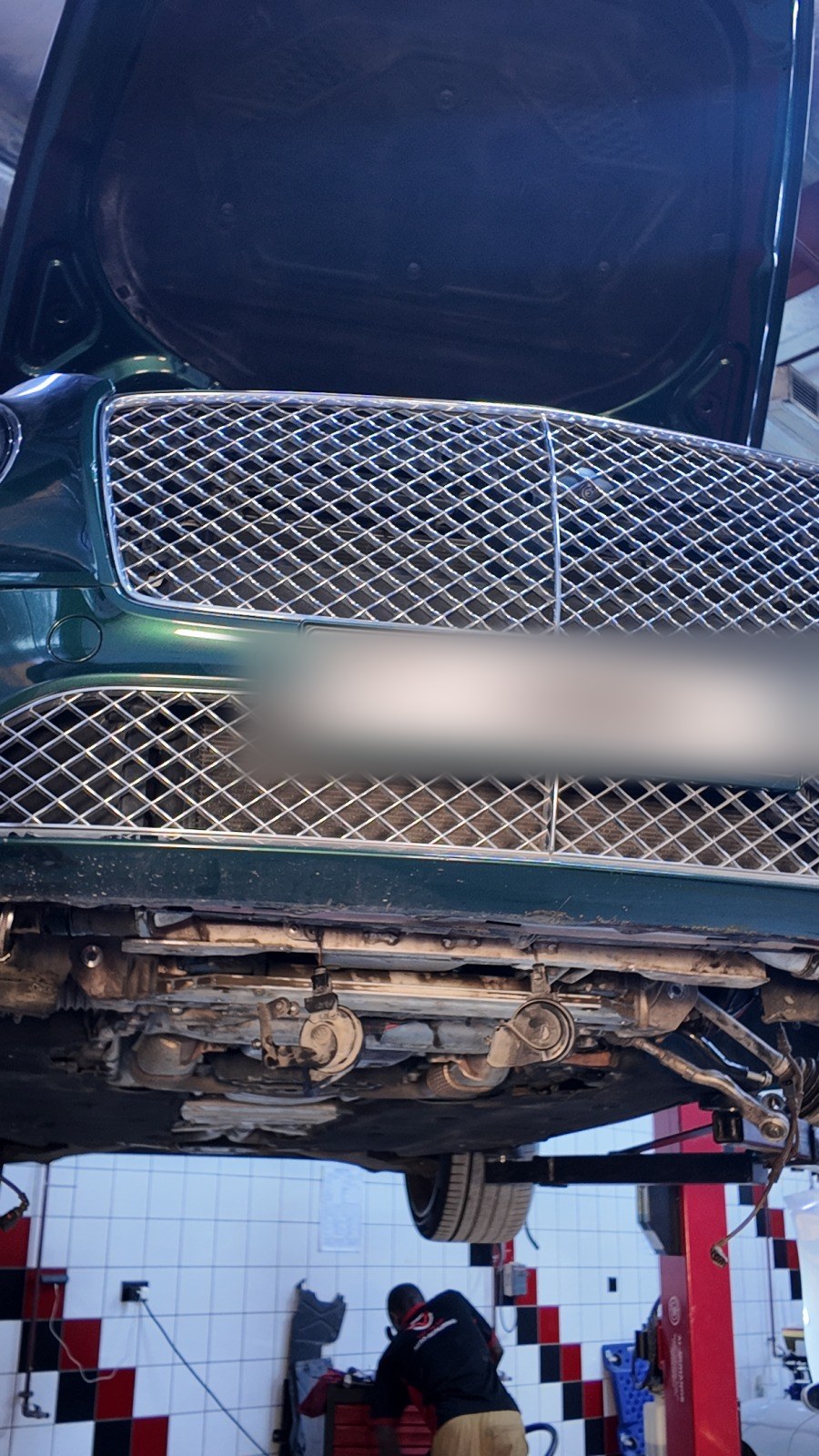 Green Bentley Continental GT raised on a lift at Velokar Auto Repairing, Al Quoz Industrial 3