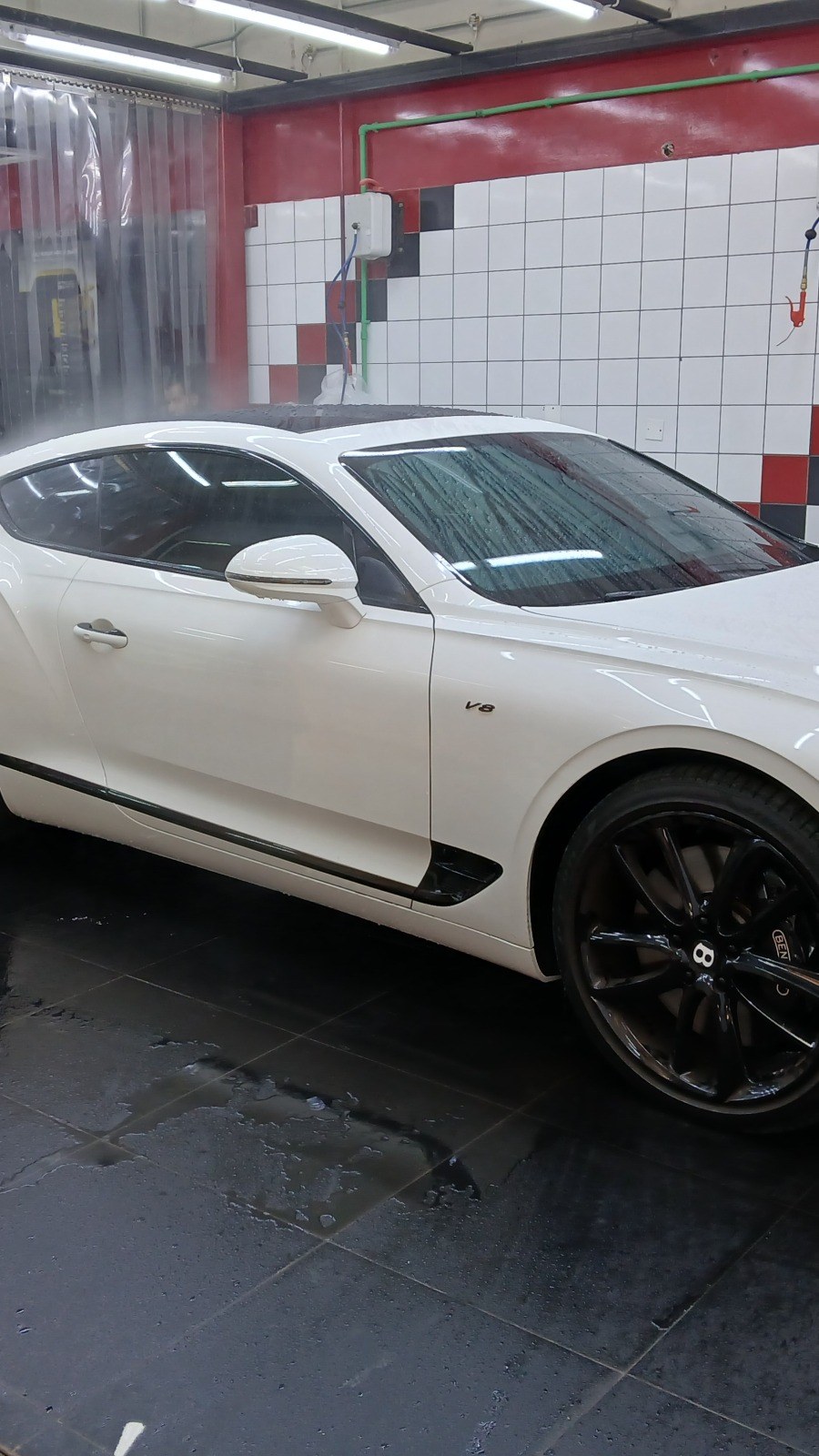 White Bentley Continental GT in a service bay at the Velokar workshop in Dubai