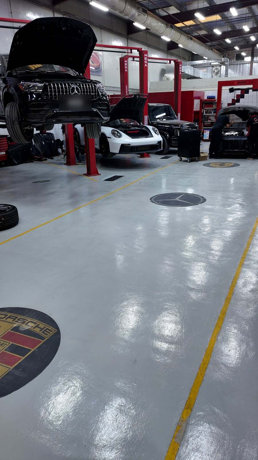 Velokar workshop floor in Al Quoz with cars on lifts