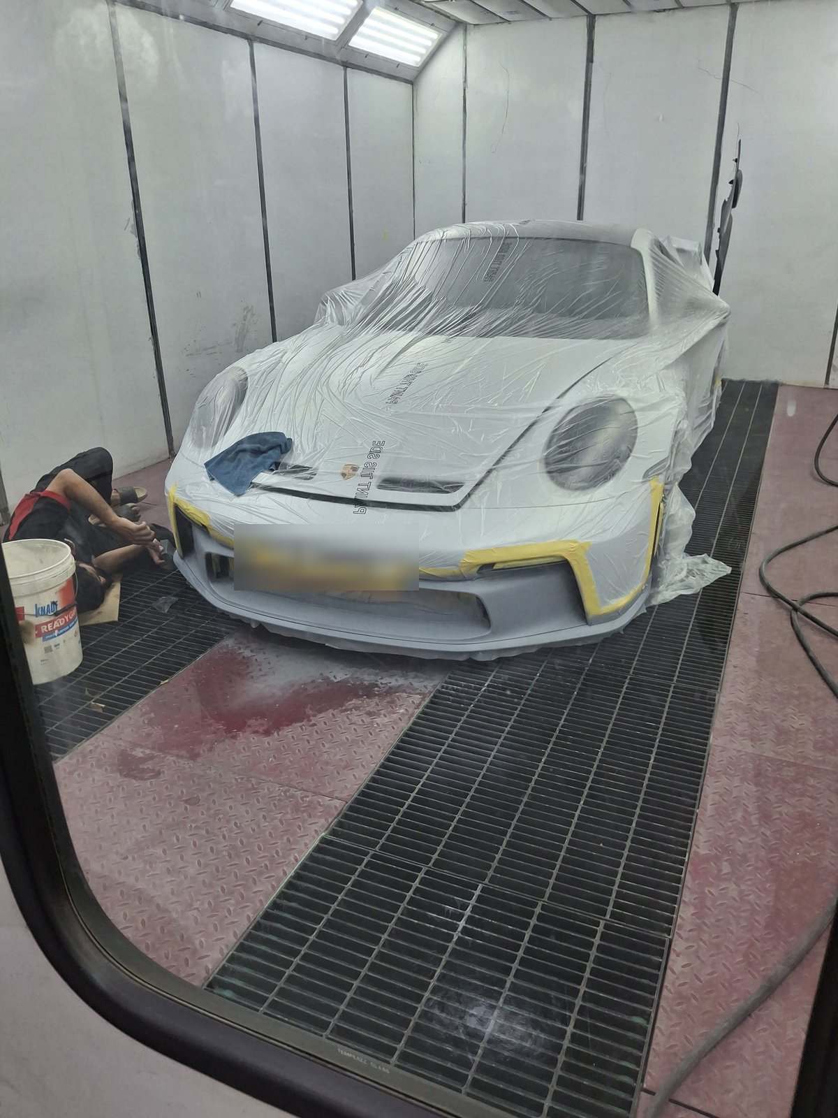 Porsche 911 GT3 masked for painting inside the paint booth at Velokar Dubai
