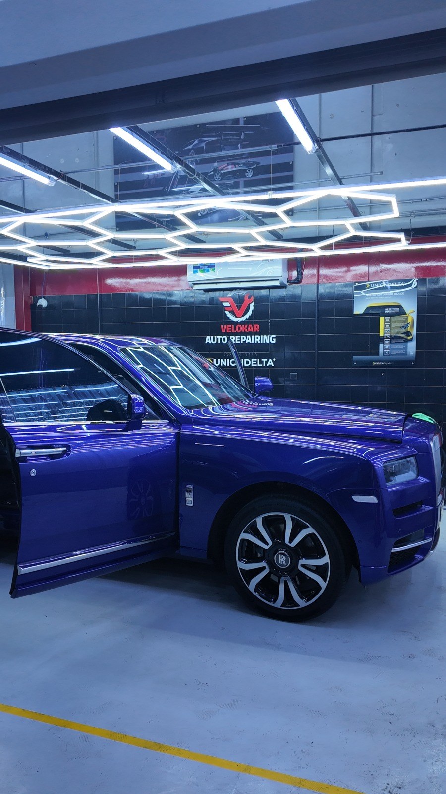 Rolls-Royce Cullinan parked inside the Velokar workshop in Al Quoz under the workshop lights