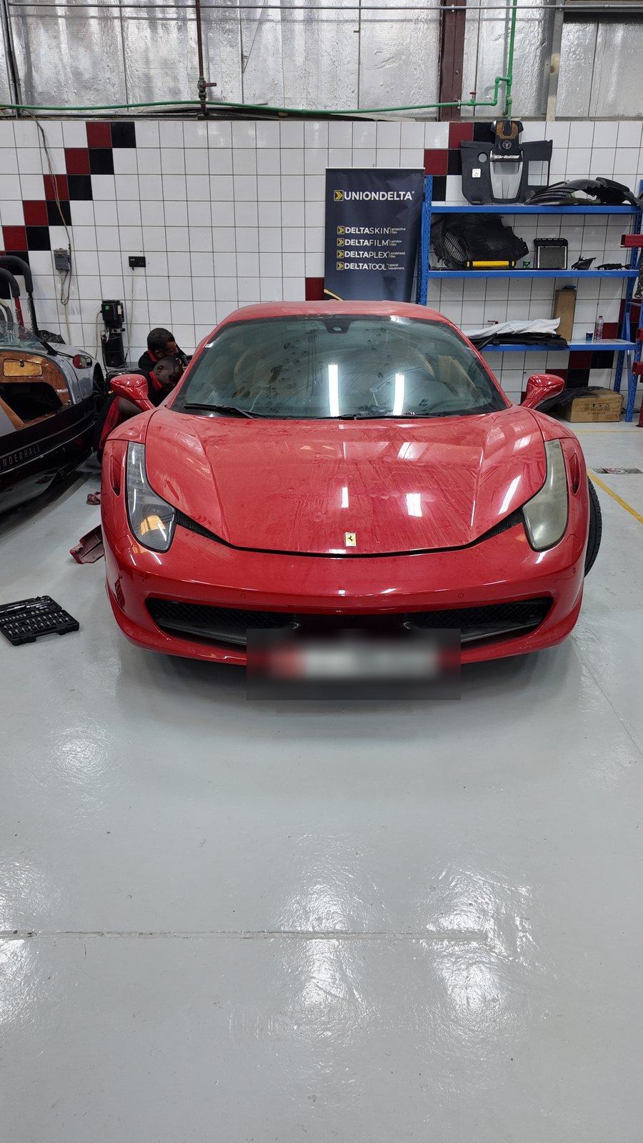 Red Ferrari 458 Italia front view in the Velokar workshop in Al Quoz, Dubai