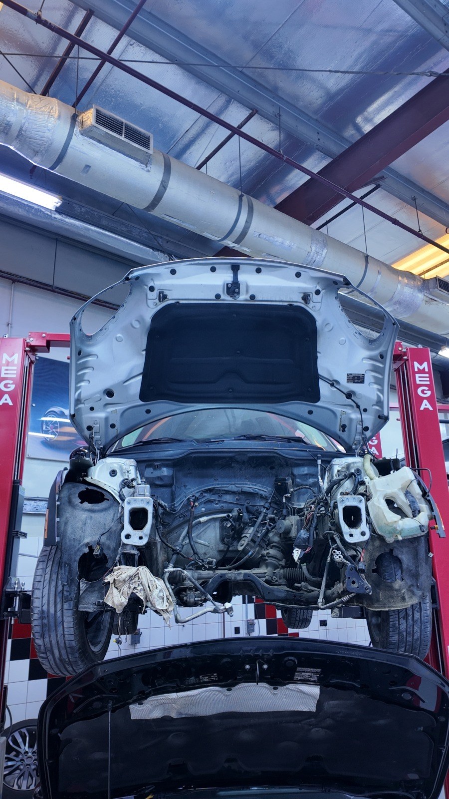 Range Rover on the lift at Velokar with the front bumper and radiator removed for engine and gearbox access