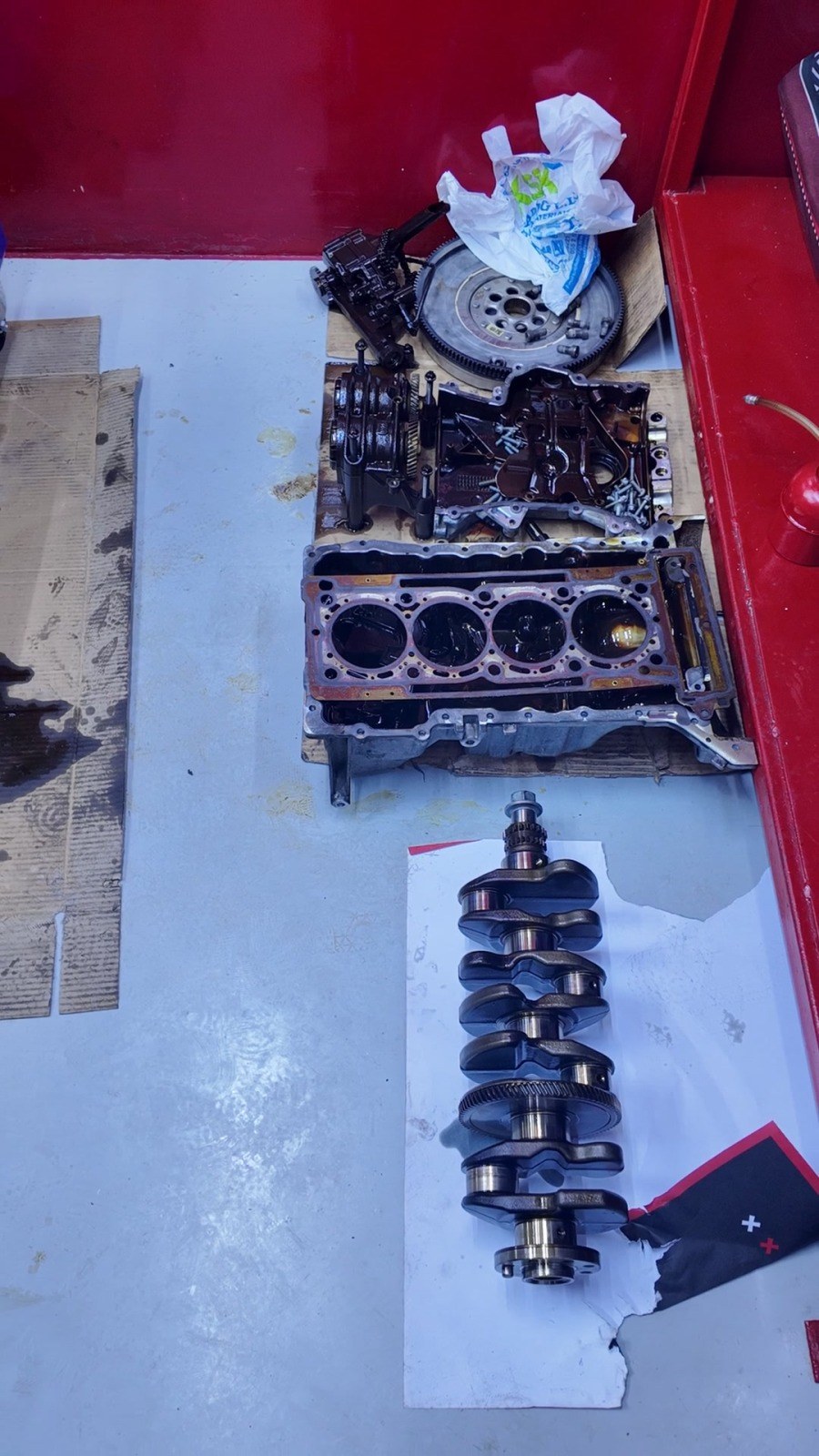 Engine block, crankshaft, flywheel and timing cover laid out on the bench at Velokar in Al Quoz before the parts decision