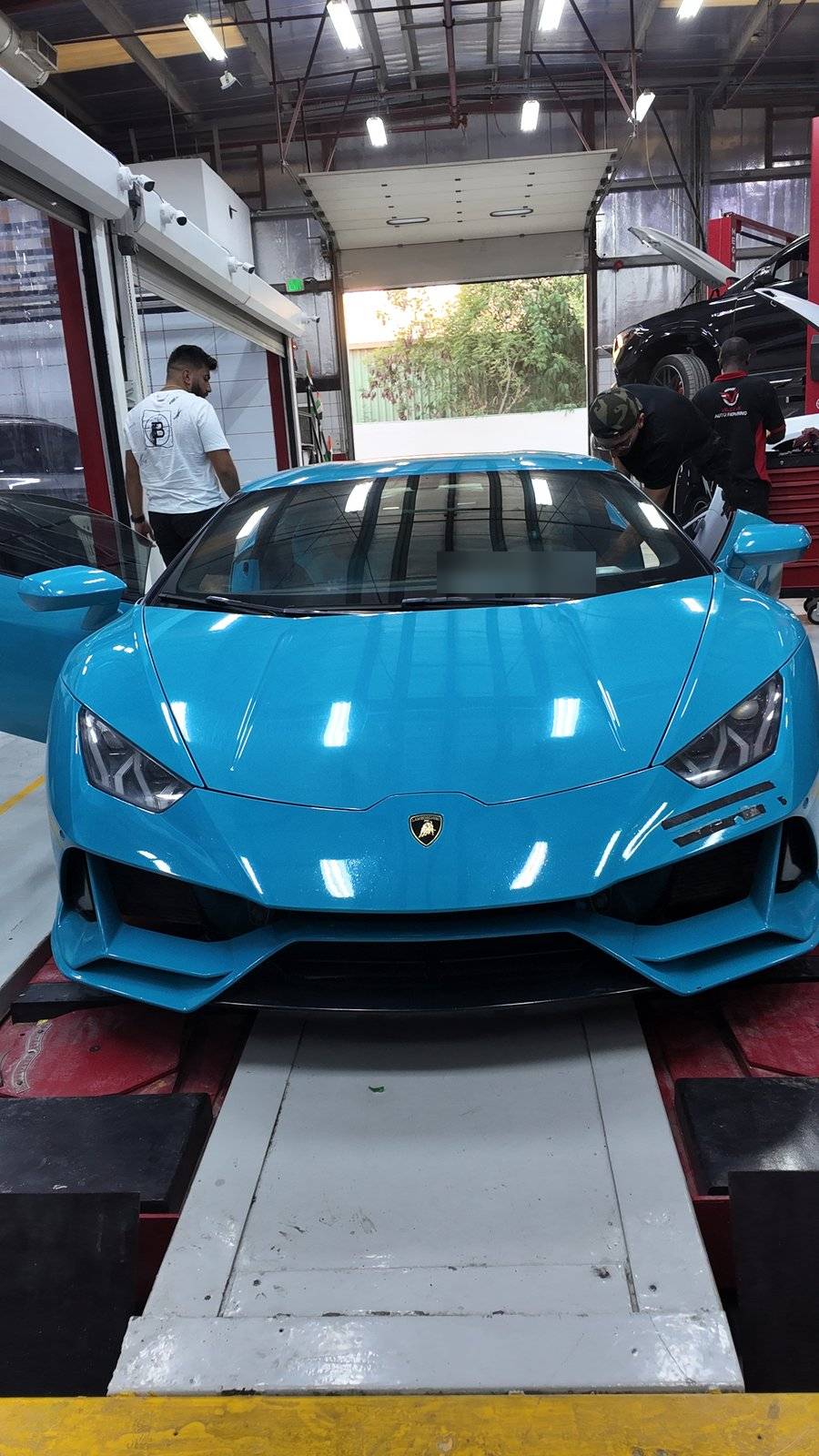 Lamborghini Huracan on the alignment lift inside Velokar Dubai