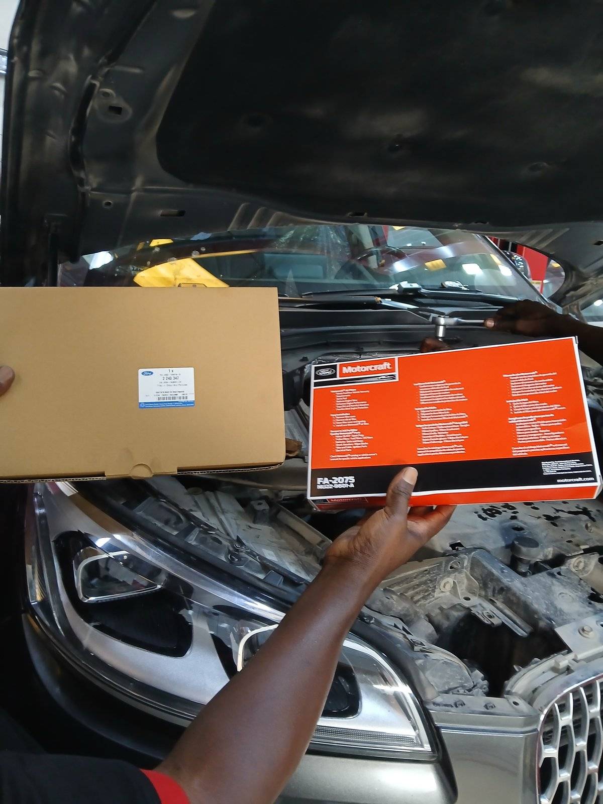Motorcraft and Ford OEM parts boxes over a Lincoln engine bay at Velokar