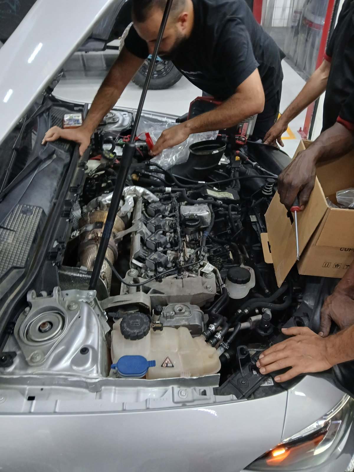 Velokar technicians working on a Mercedes CLA engine