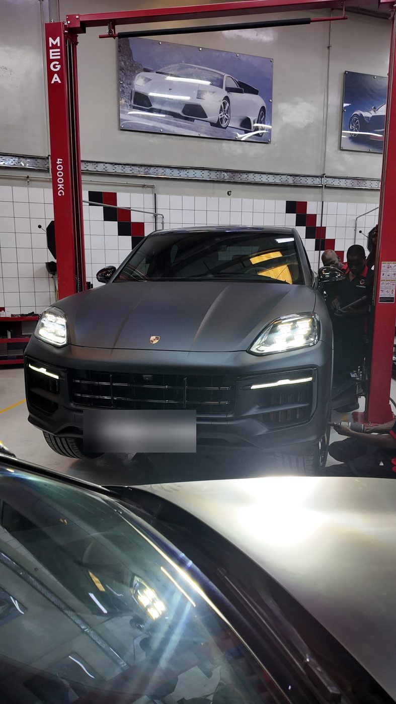 Matte grey Porsche Cayenne on the lift at Velokar Dubai