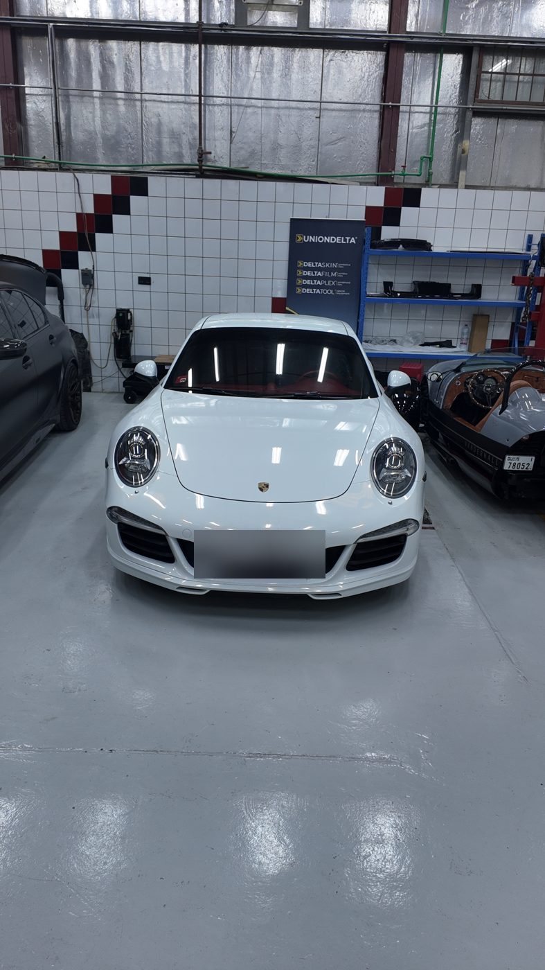 White Porsche 911 in the Velokar Auto Repairing workshop in Al Quoz, Dubai