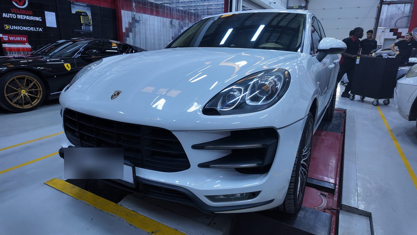 White Porsche Macan in the Velokar workshop bay in Al Quoz