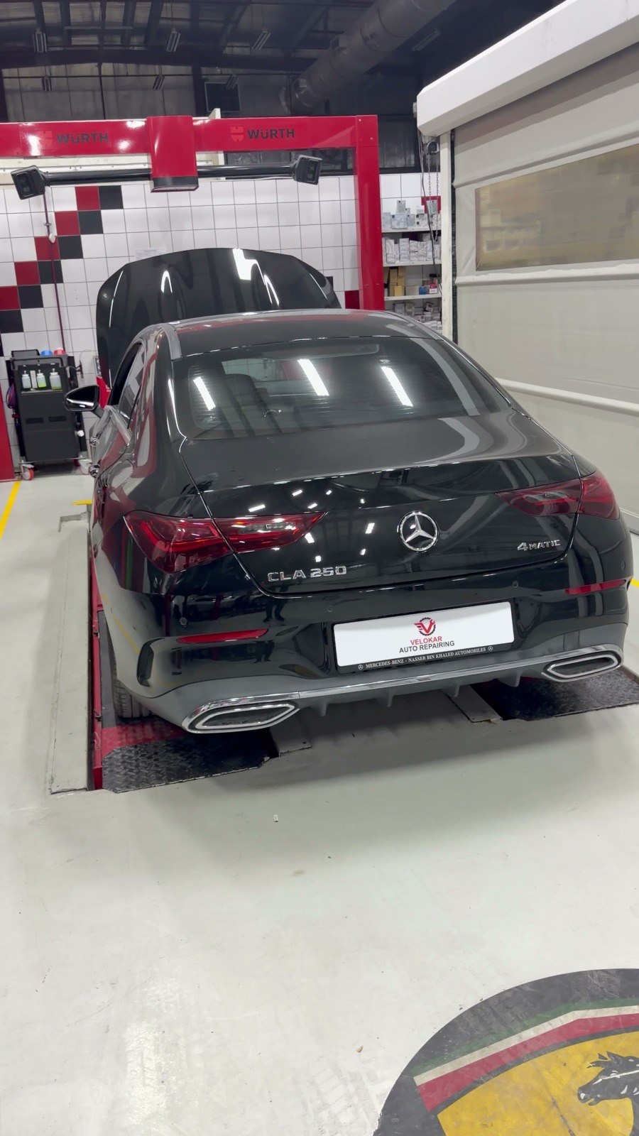 Black Mercedes CLA 250 on a drive-on lift in a Velokar workshop bay, Al Quoz Industrial 3, Dubai