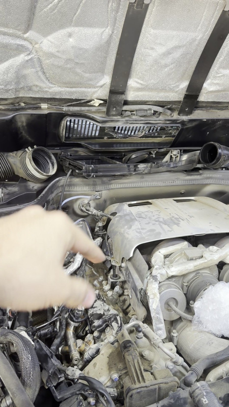 Technician pointing at a component in an open Mercedes engine bay at Velokar, Al Quoz