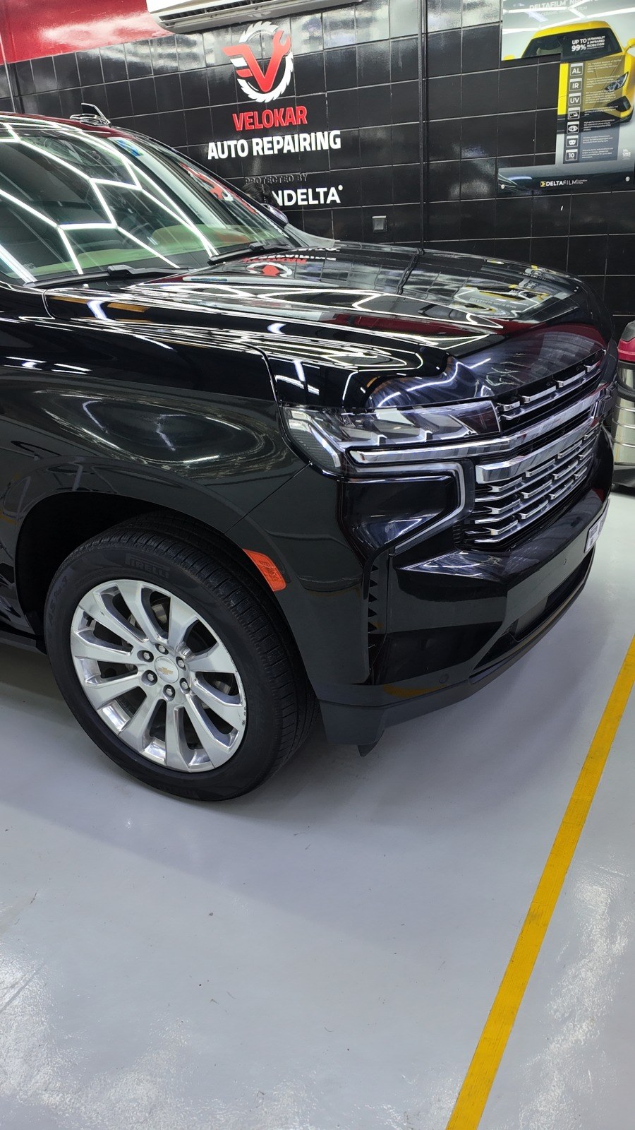 Black Chevrolet Tahoe, a US-spec SUV, in the service bay at Velokar Auto Repairing, Al Quoz Industrial 3, Dubai