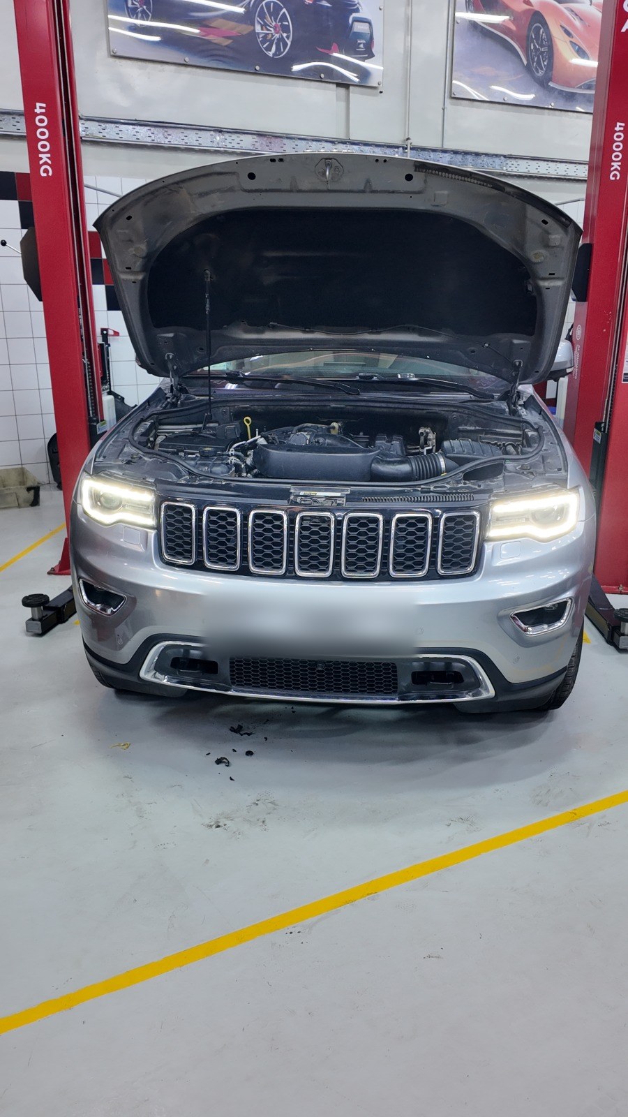 Jeep Grand Cherokee on the lift with the bonnet open at Velokar in Al Quoz, Dubai
