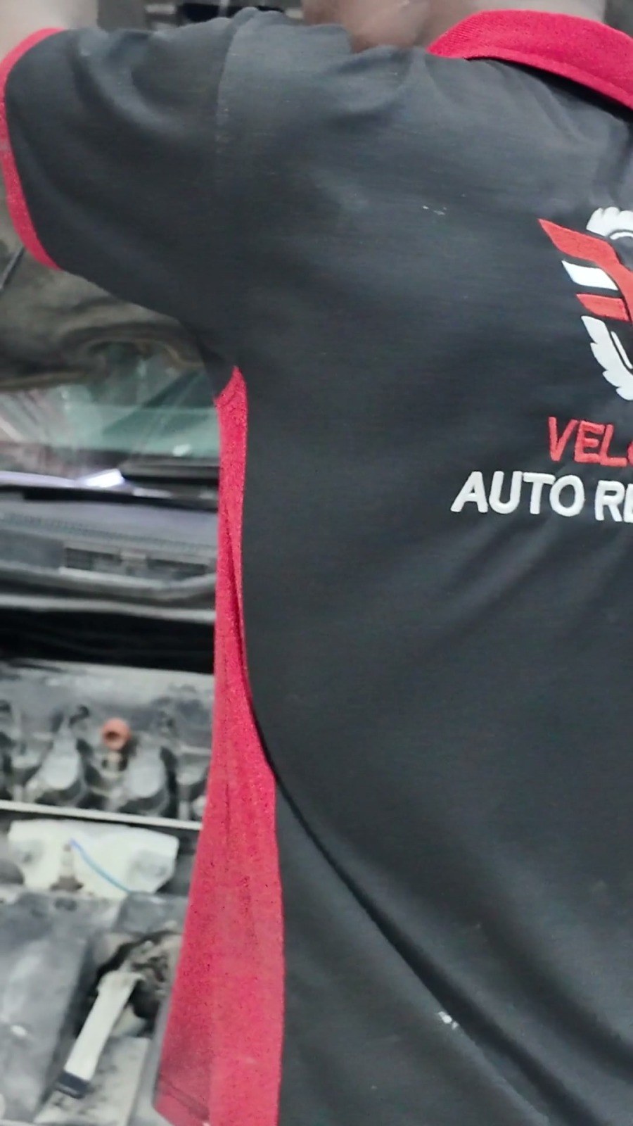Velokar technician working in an open engine bay at the Al Quoz workshop, Dubai